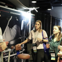 guy in gray shirt address four women at a conference