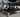 Black Vyper Low Pro chair in garage next to black car
