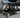 Black Vyper Low Pro chair in garage next to black car
