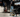 Man in black shirt and jeans working in garage with Vyper chair in the foreground