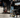 Man in black shirt and jeans working in garage with Vyper chair in the foreground